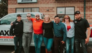 Photograph of the Axe Roofing team posing in front of a truck in Colorado